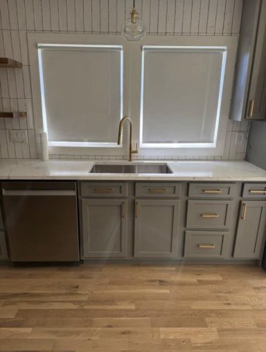 Kitchen Remodel – Completed Completed kitchen remodel with gray cabinets, stone counters and wood flooring